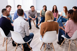 group in white chairs in an opiate addiction treatment program