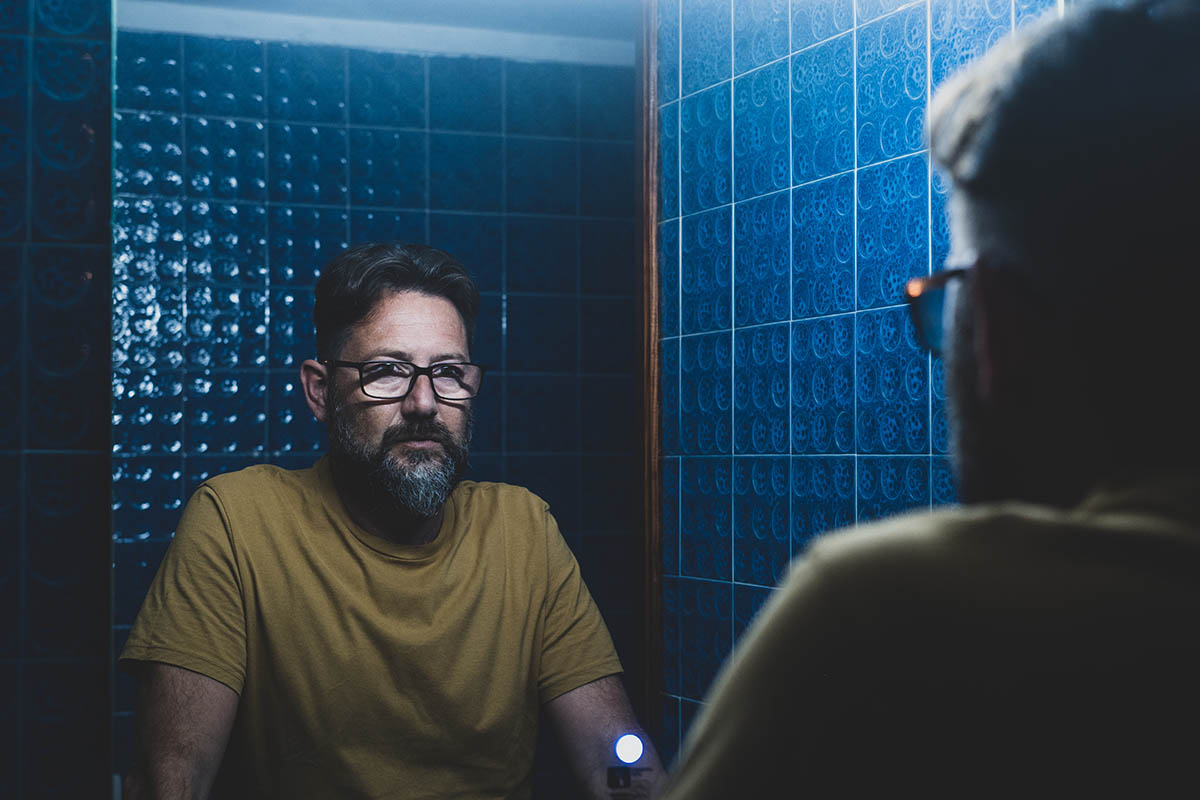 man in blue bathroom considering the most commonly abused opioids