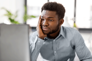 man looks at screen and thinks about high functioning anxiety