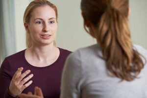 woman talking to friend about person-centered therapy