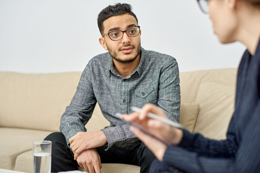 man with glasses talks with a therapist in outpatient rehab in lexington