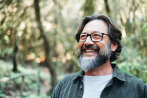 A man thinking about CBT strategies and smiling