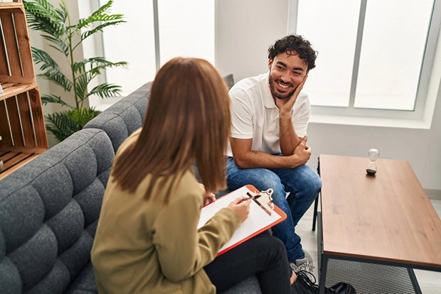 A man talks to a provider about insurance coverage for addiction treatment.
