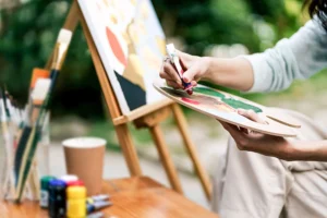 A person participates in art therapy, one of many experiential therapies for treating trauma.