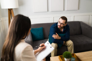 Man talking to a woman therapist about what's an addictive personality.